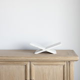 Marble book stand on a wooden surface with a plain background