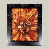Framed artwork with a close-up of a Dahlia in vibrant orange and red colours on a grey background.