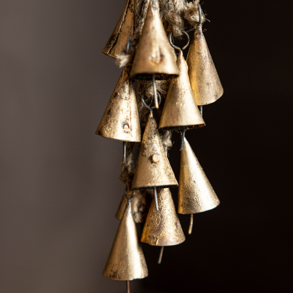 Decorative hanging brass bells on a dark background