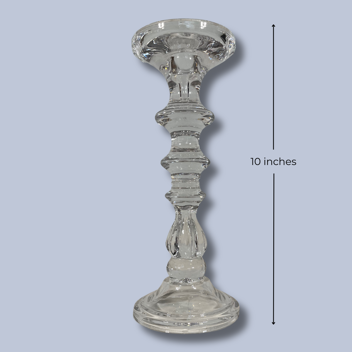 Clear glass candlestick on a light blue background with a measurement label indicating 10 inches.