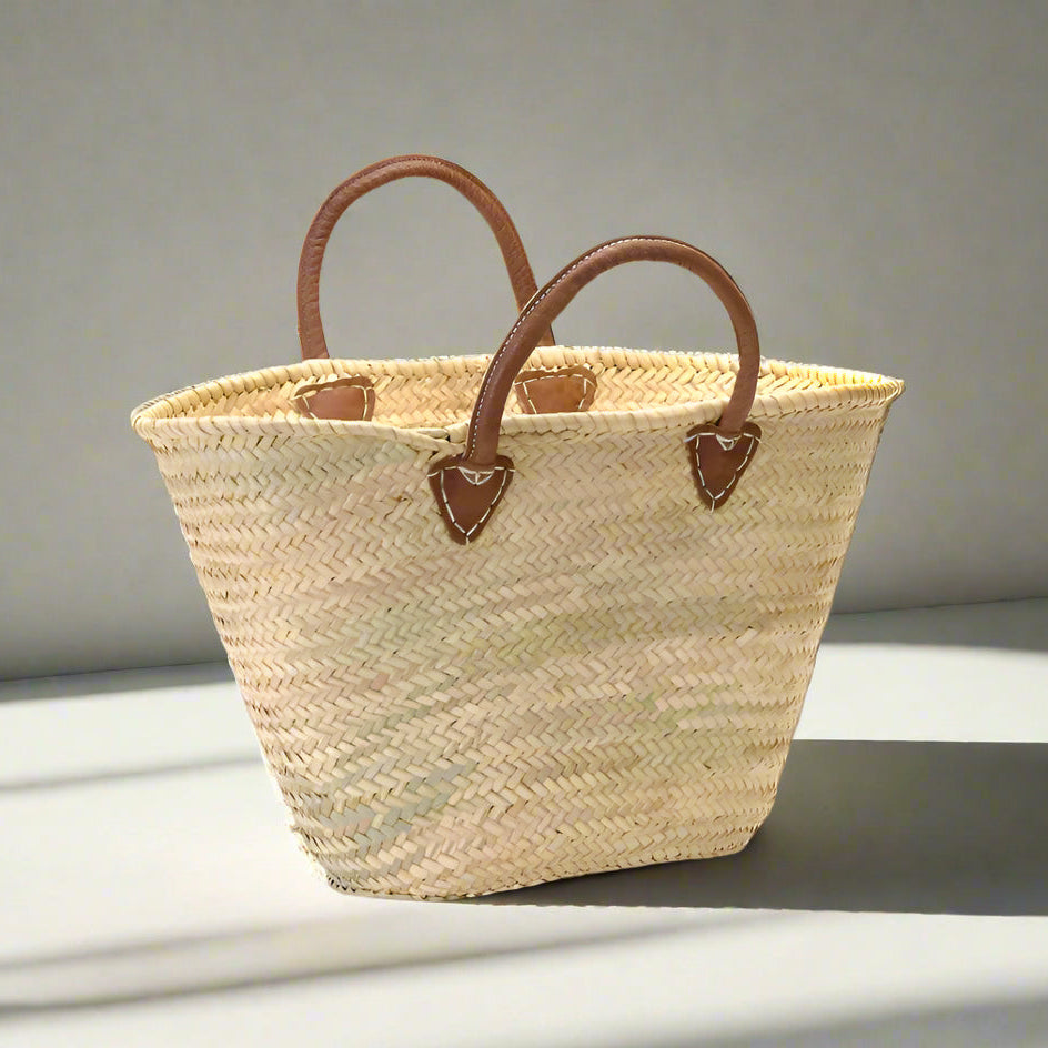 Rustic yet elegant handwoven basket, embodying traditional French charm. Perfect for carrying your market treasures with ease; the sturdy yet supple leather handles provide both durability and a touch of effortless style.