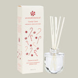 Aromatherapy diffuser with reeds and packaging featuring candy cane design on a white background