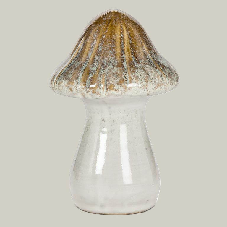 Ceramic mushroom with a brown cap and white stem on a pale green background