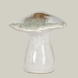 Ceramic mushroom sculpture with a greenish-brown cap on a pale green background