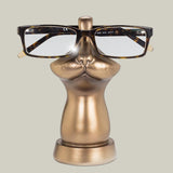 Bronze coloured eye glass holder that is shaped like the lower portion of a cat's face.