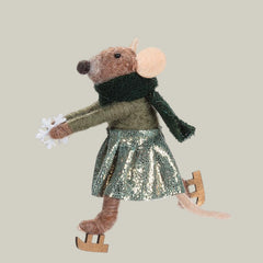 Decorative mouse ornament with a scarf, skirt, and skates on a pale green background