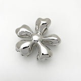 Silver flower-shaped object on a white background
