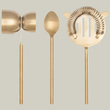 Our Gilded Bar Tool set featuring a beautiful matte gold finish cocktail strainer, mixing spoon and dual sized measuring tool