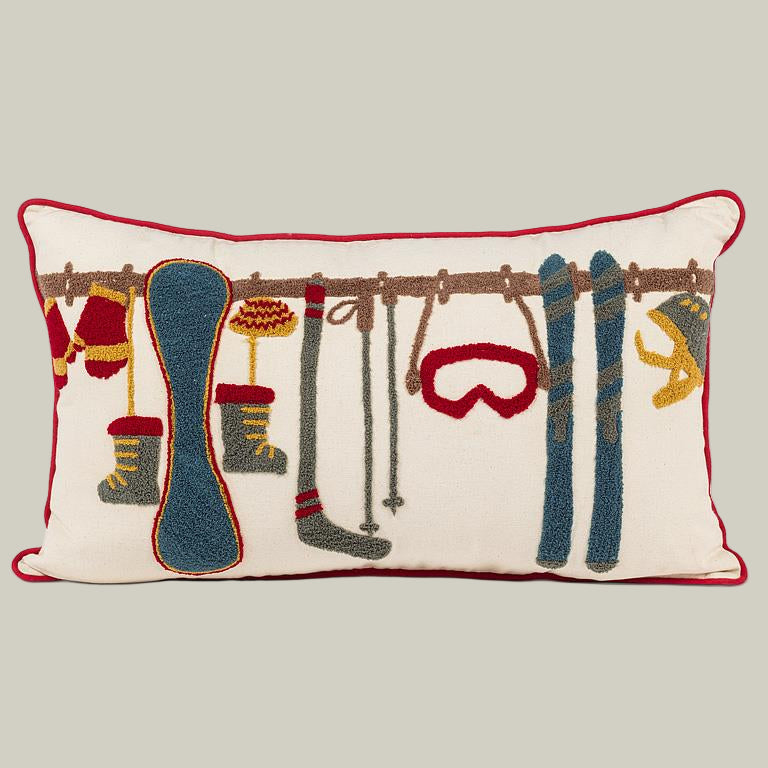 Decorative pillow with skiing-themed illustrations on a white background