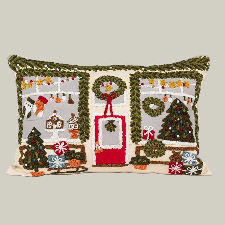 Decorative pillow with Christmas-themed storefront embroidery on a white background