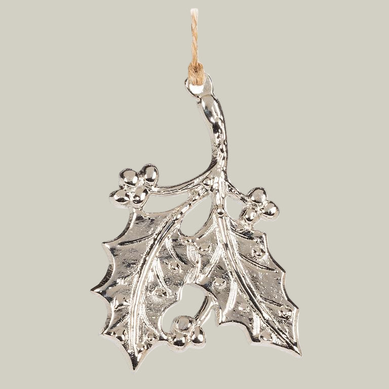 Silver holly leaf ornament on a white background