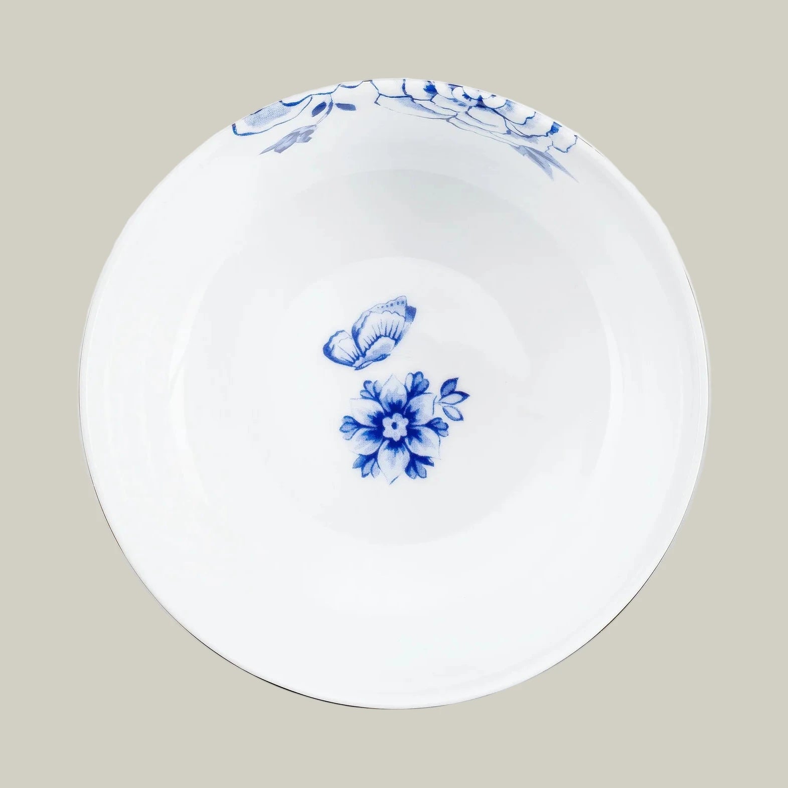 Top view of a porcelain bowl from Pip Studio Royal White collection with blue floral design and gold accents.