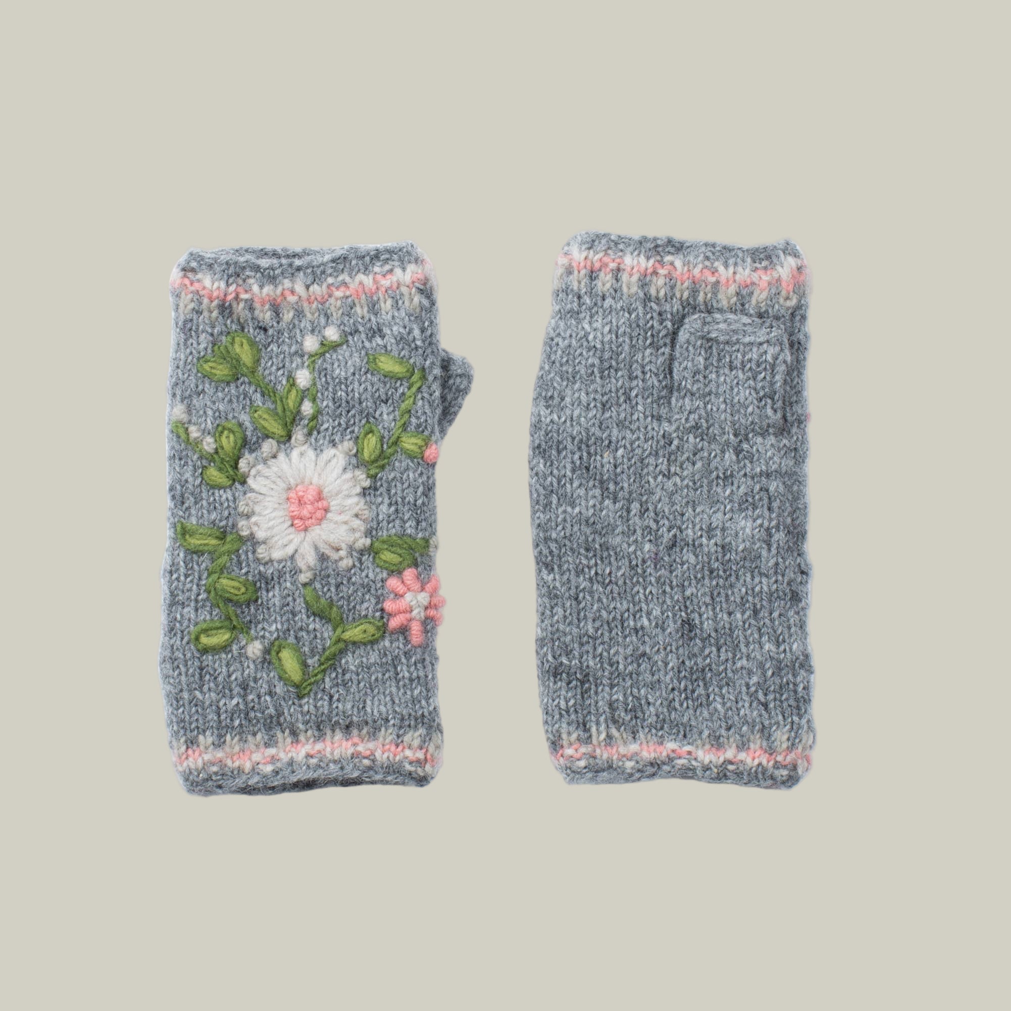 Pair of grey hand-knitted fingerless gloves also know as handwarmers with floral embroidery