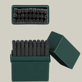 Set of metal stamps in a green box on a light green background