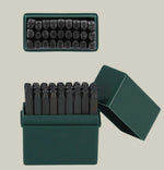 Set of metal stamps in a green box on a light green background 3