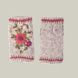 Pair of hand-knitted fingerless gloves, also known as handwarmers with floral embroidery 