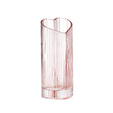 Blush heart shaped glass vase on a white background.
