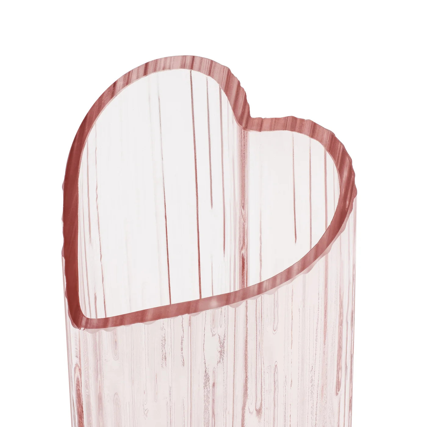 Close-up of the opening of a blush coloured heart shaped glass vase on a white background