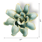 A decorative ceramic flower sculpture with a glossy light blue-green glaze and pale yellow edging, shown on a white background with dimension lines indicating 5 1/4 inches wide and 5 1/2 inches tall.