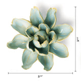 A decorative ceramic flower sculpture with a glossy light blue-green glaze and pale yellow edging, shown on a white background with dimension lines indicating 5 1/4 inches wide and 5 1/2 inches tall.