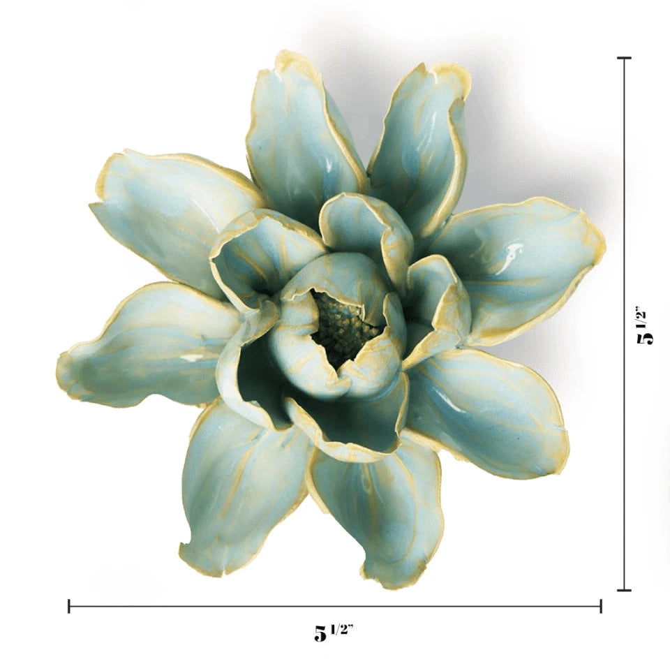 A decorative ceramic flower sculpture with a glossy light blue-green glaze and pale yellow edging, shown on a white background with dimension lines indicating 5 1/4 inches wide and 5 1/2 inches tall.
