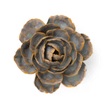 A ceramic English Rose sculpture with layered petals in muted gray-blue and warm bronze-brown tones, photographed from above on a plain white background.