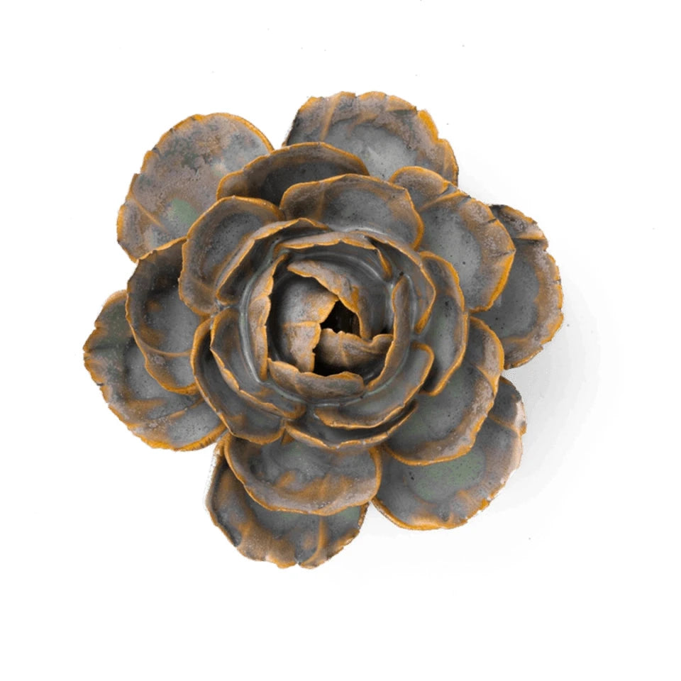 A ceramic English Rose sculpture with layered petals in muted gray-blue and warm bronze-brown tones, photographed from above on a plain white background.