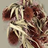 Meticulously crafted 10-inch accent wreath with it's lush burgundy red teasels providing a striking focal point against the delicate, ethereal sprays of Bupleurum in a soft pink and natural willow eucalyptus adds a graceful touch of olive green.