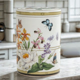 Decorative bone china jar with floral and butterfly design on a kitchen counter.