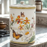 Decorative bone china jar with floral and butterfly design on a kitchen counter.