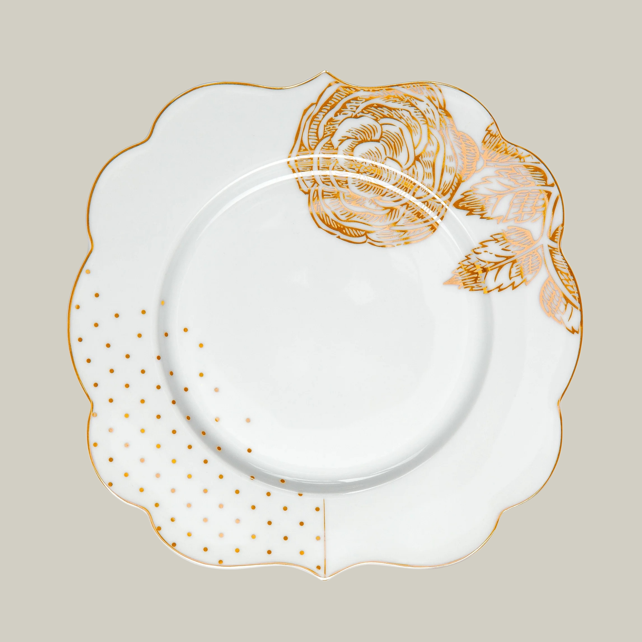 Porcelain white cake plate with gold and blue floral patterns on a soft green background