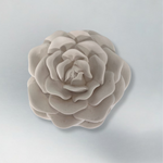 Decorative candle in container with floral designed lid