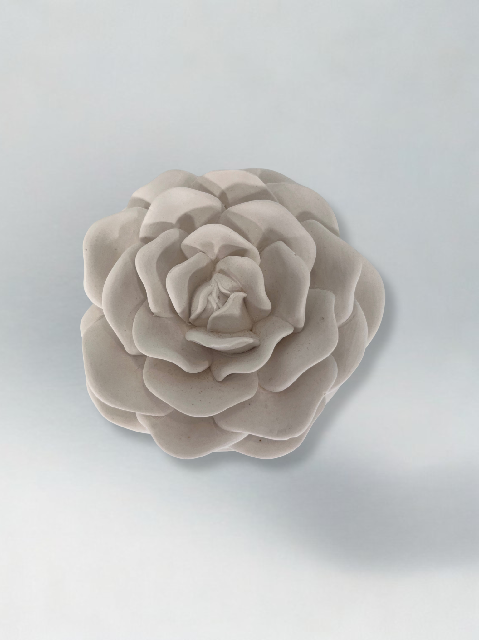 Decorative candle in container with floral designed lid
