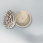 Ceramic container with candle and a rose design on the lid