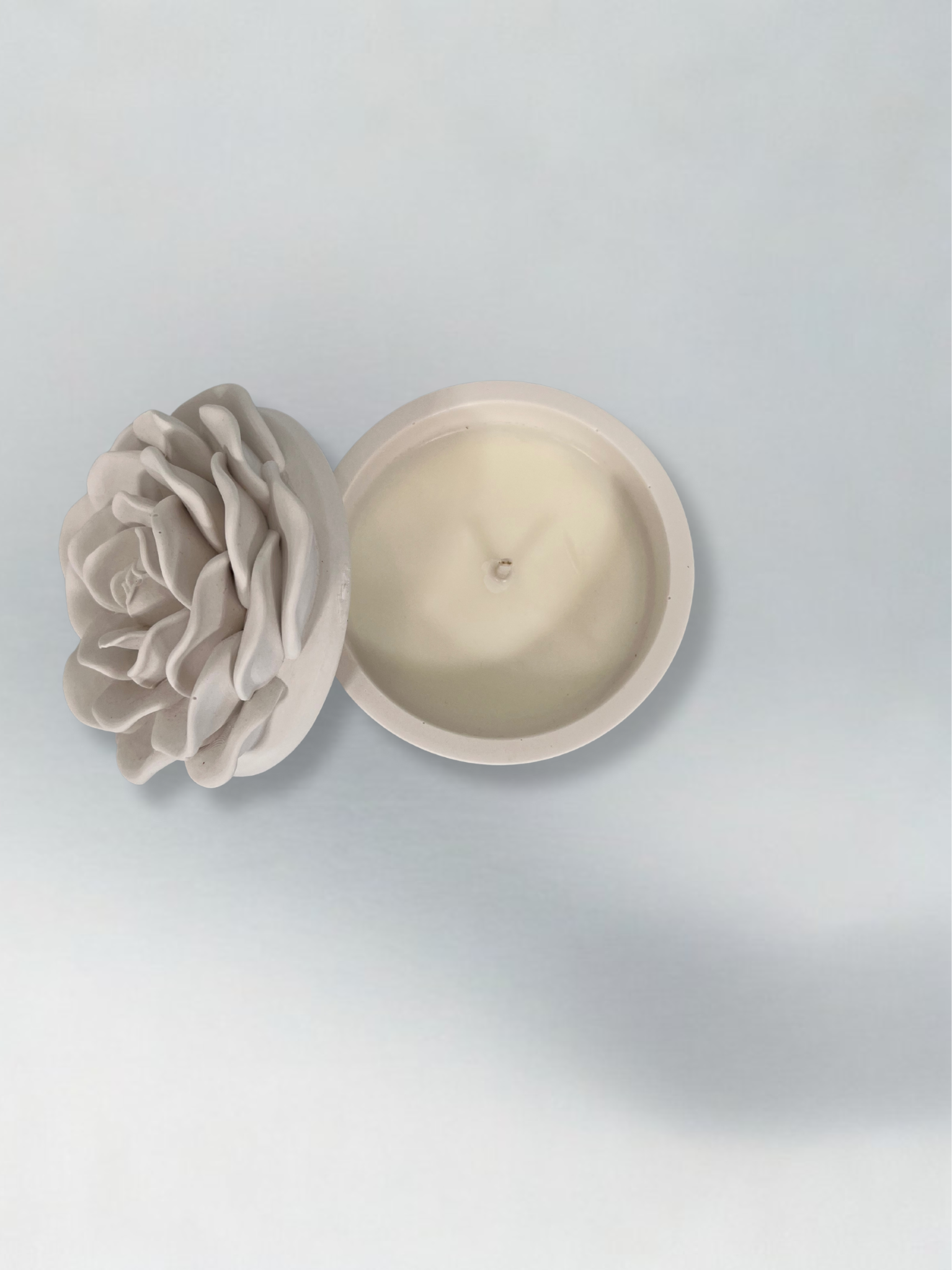 Ceramic container with candle and a rose design on the lid