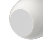 Close-up of the bottom of a white ceramic vase with crackle glaze and a floral appliqué on a white background. the bottom has a soft white foam covering to prevent surface scratches from occuring.