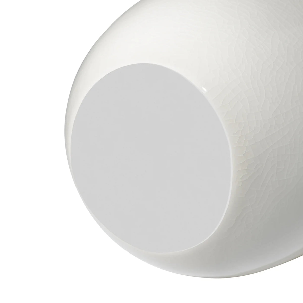 Close-up of the bottom of a white ceramic vase with crackle glaze and a floral appliqué on a white background. the bottom has a soft white foam covering to prevent surface scratches from occuring.
