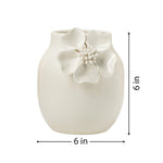 White ceramic vase with crackle glaze and a floral appliqué on a white background with dimensions of 6 inches tall and 6 inches in diameter.