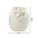 White ceramic vase with crackle glaze and a floral appliqué on a white background with dimensions of 6 inches tall and 6 inches in diameter.