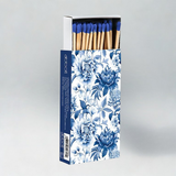 Matches with a blue and white chintz floral patterned box on a gray background