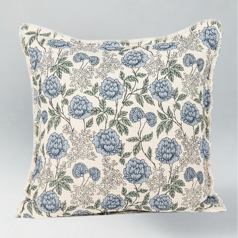 Floral patterned pillow with blue flowers on a ivory background