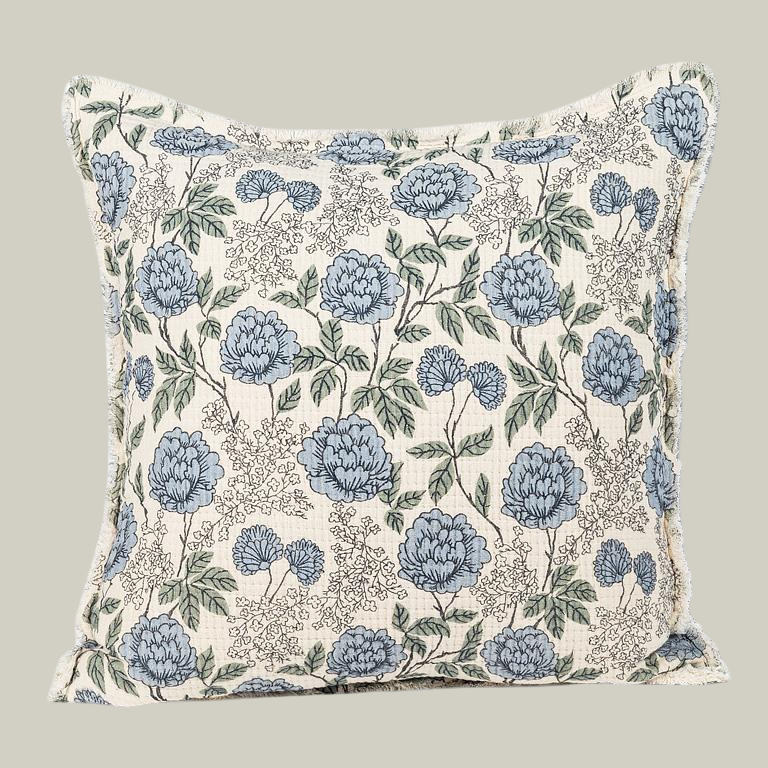 Floral patterned pillow with blue flowers on a ivory background