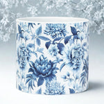 Ceramic planter with blue floral design on a light background