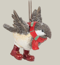 Decorative winter chickadee ornament wearing a red scarf and boots on a pale green background