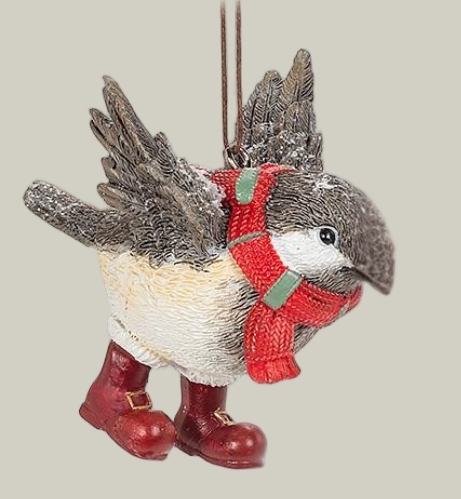 Decorative winter chickadee ornament wearing a red scarf and boots on a pale green background