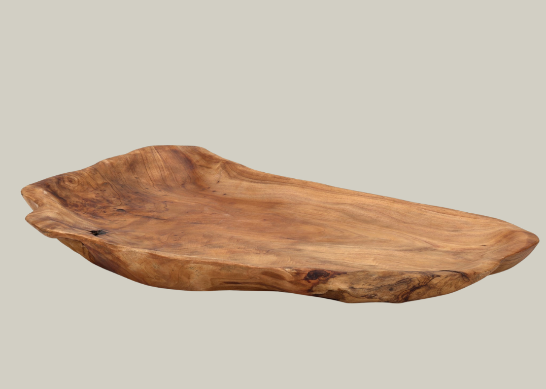 Wooden platter platter that was hand-carved from fir stumps left by logging industry on a beige background.