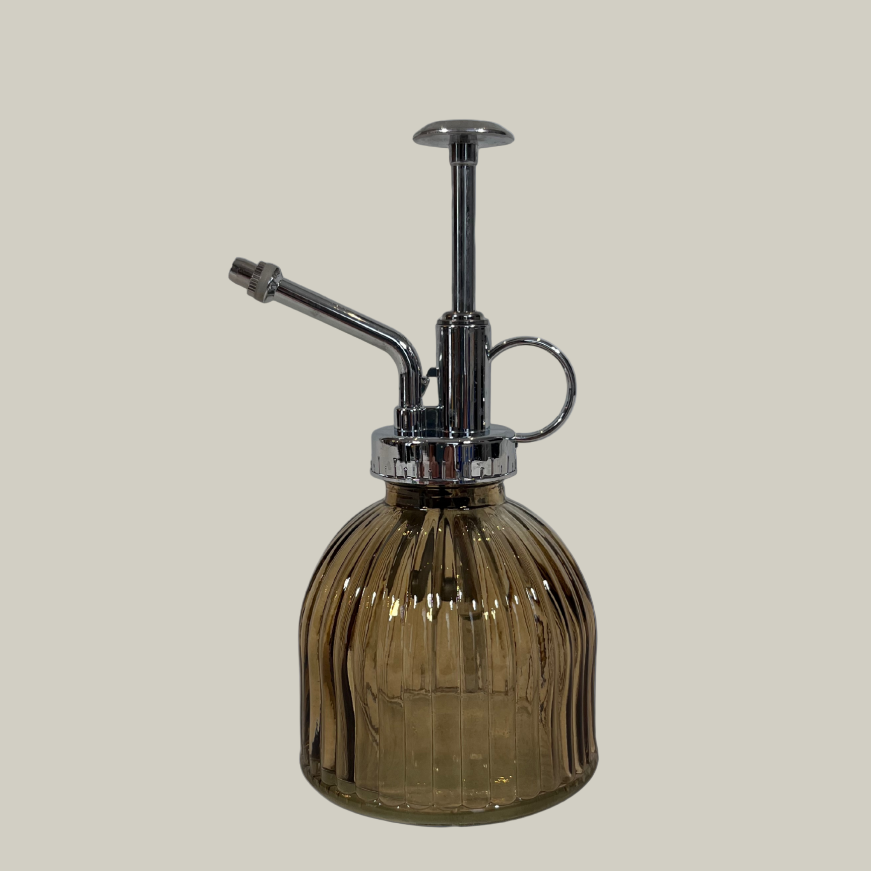 Vintage-style glass spray bottle with ribbed design on a light gray background
