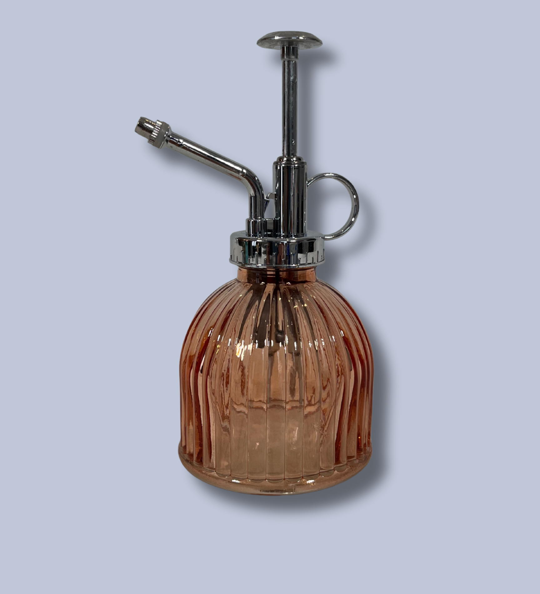 Vintage-style brown glass atomizer with chrome top on a light gray background