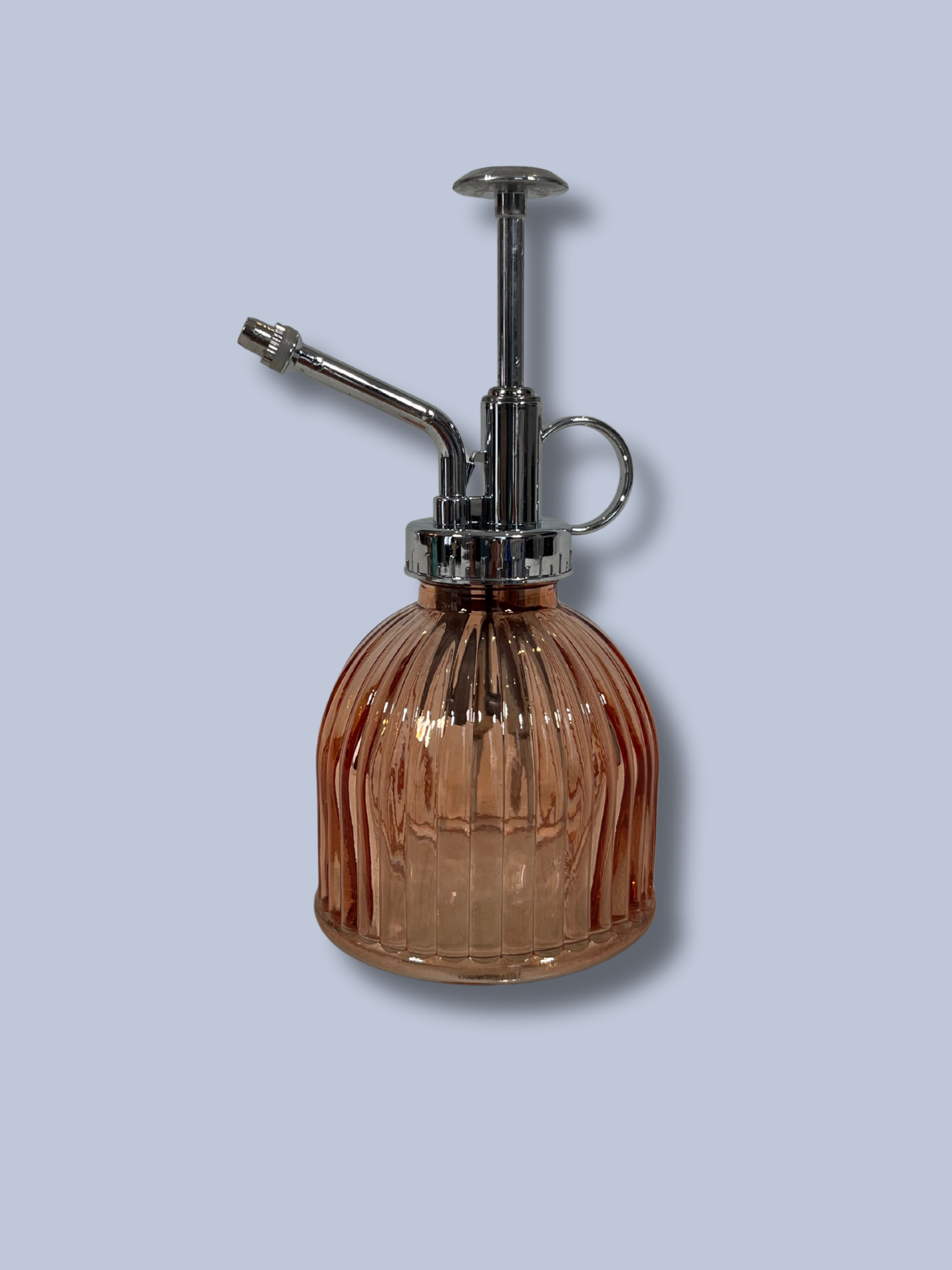 Vintage-style brown glass atomizer with chrome top on a light gray background