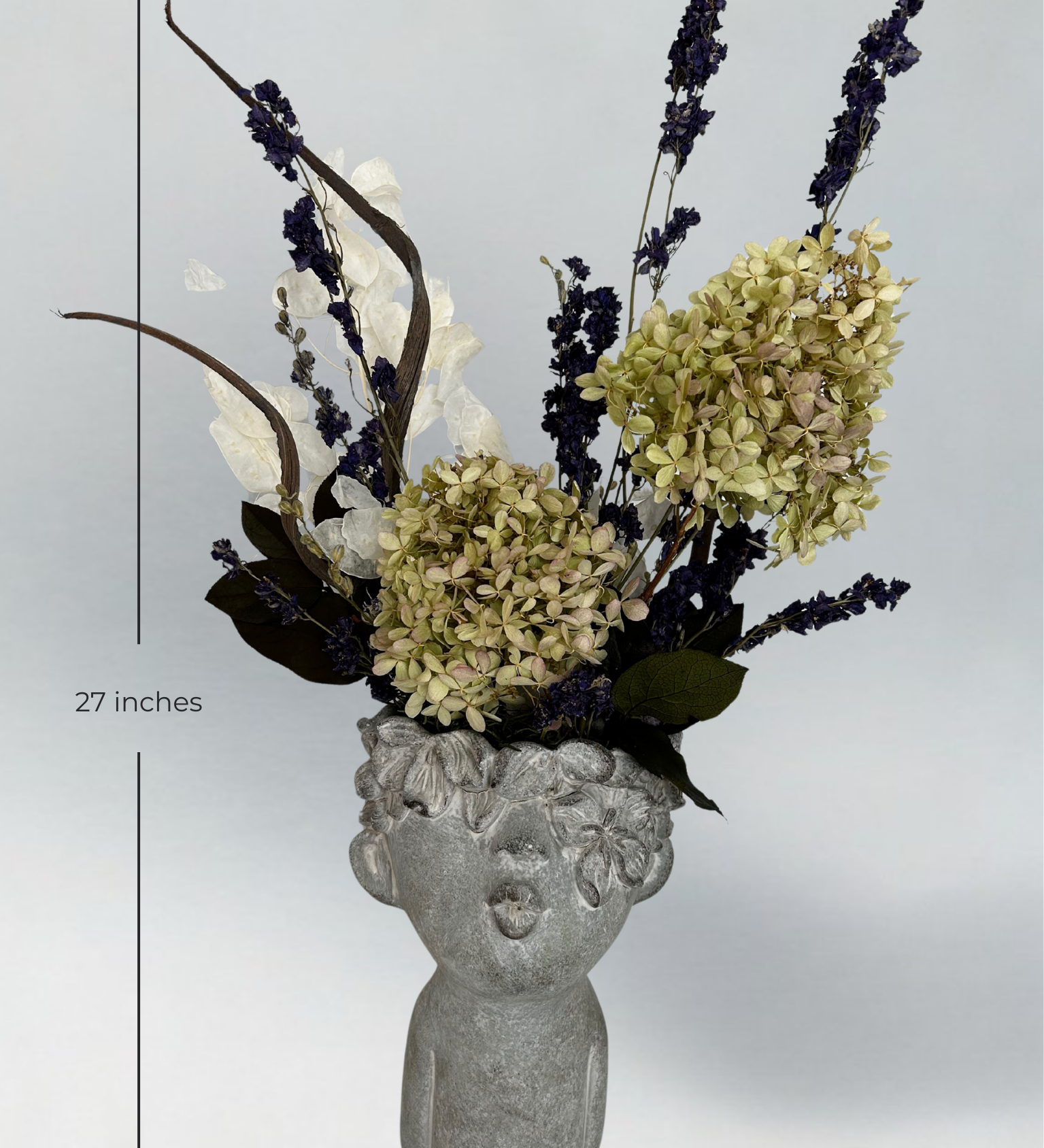 Decorative concrete vase with everlasting floral arrangement on a gray background